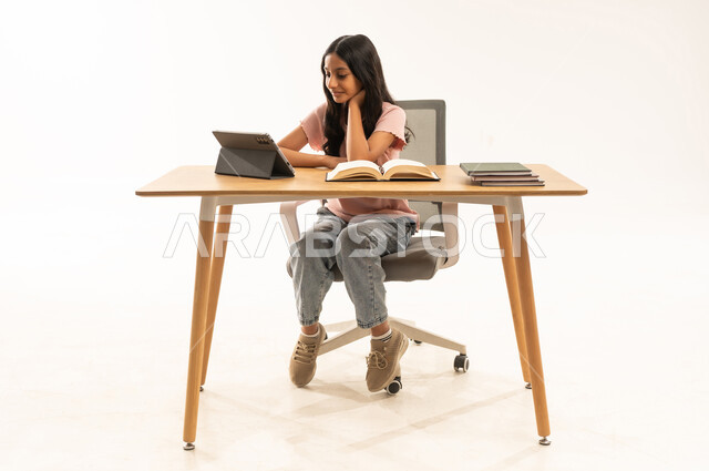 Saudi Girl Studying with Tablet and Books at Desk