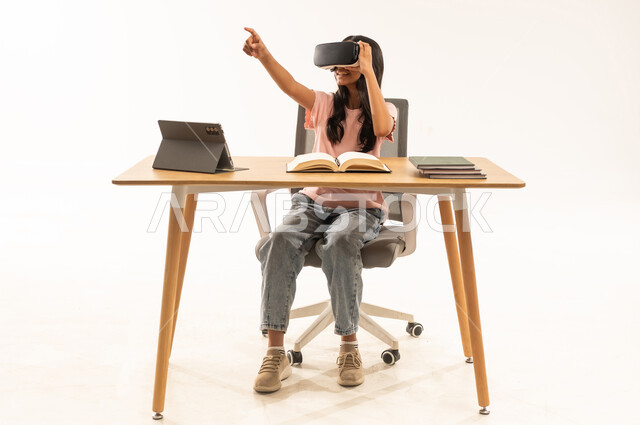 Arab Schoolgirl Using VR Headset at Study Desk