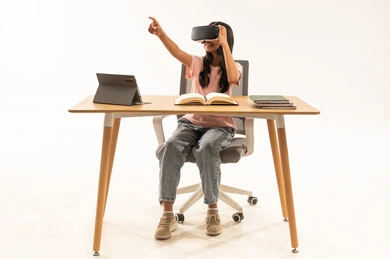 Arab Schoolgirl Using VR Headset at Study Desk