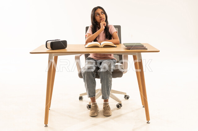 Arab Student Thinking at Desk with VR Headset