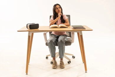 Arab Student Thinking at Desk with VR Headset