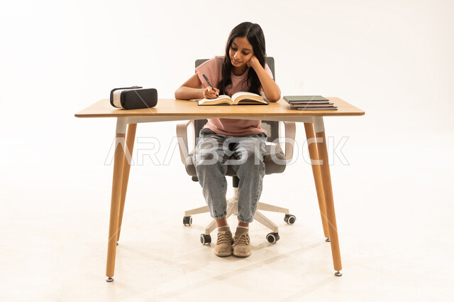 Arab Girl Studying at Desk with VR Headset