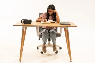 Young Saudi Girl Studying at Wooden Desk