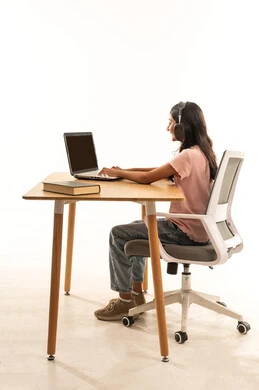Arab Girl Using Laptop with Headphones at Desk