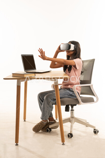 Arab Girl Using VR Headset and Laptop at Desk