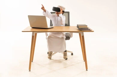 Omani Boy Using VR Headset at Office Desk