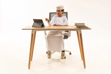 Omani Boy Using Tablet at Desk in Studio