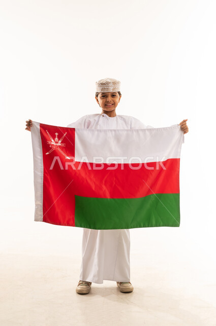 Omani Boy in Traditional Dress Holding Oman Flag