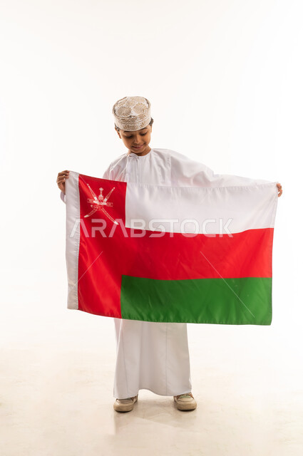 Omani Boy in Traditional Dress Holding National Flag