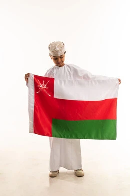 Omani Boy in Traditional Dress Holding National Flag