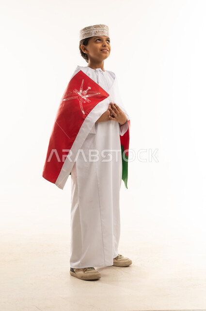 Omani Boy in Traditional Dress with National Flag