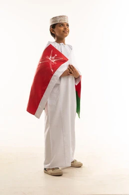 Omani Boy in Traditional Dress with National Flag