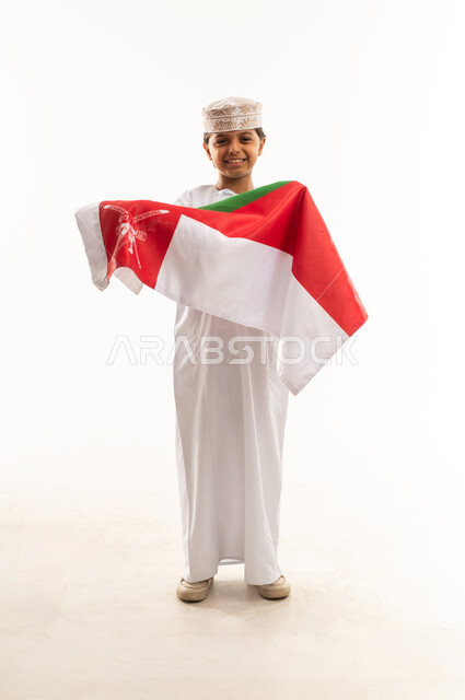 Omani Boy Wearing Traditional Dress Holding Oman Flag