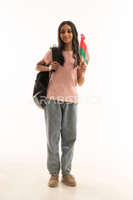 Omani School Girl Holding National Flag in Studio