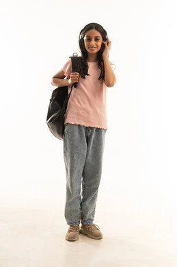 فتاة سعودية ترتدي سماعات وحقيبة مدرسية