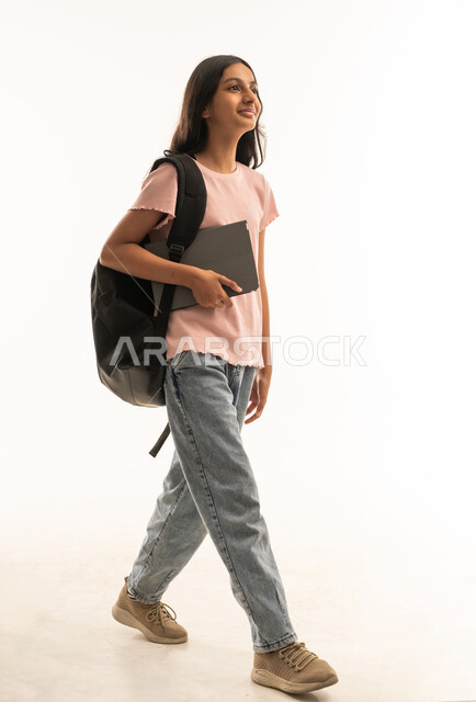 Arab Teenage Student Walking with Backpack and Laptop