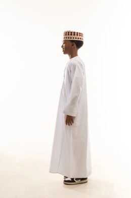 Omani Boy in Traditional White Dishdasha and Kummah