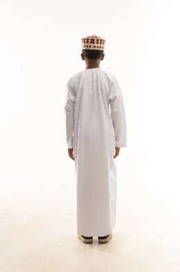 Omani Boy in Traditional Dishdasha Standing Back View