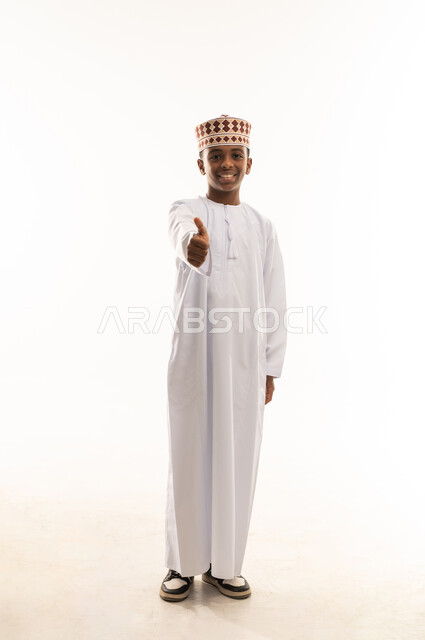 Omani Boy in Traditional Dress Giving Thumbs Up