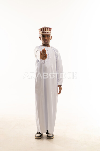 Omani Boy in Traditional Dress Making Stop Gesture