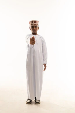 Omani Boy in Traditional Dress Making Stop Gesture