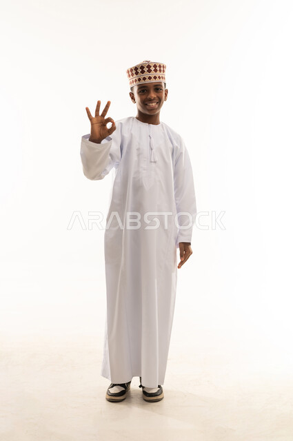 Omani Boy in Traditional Dress Making Okay Gesture