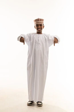 Omani Boy in Traditional Dishdasha Pointing Down Omani Boy in Traditional Dishdasha Pointing Down