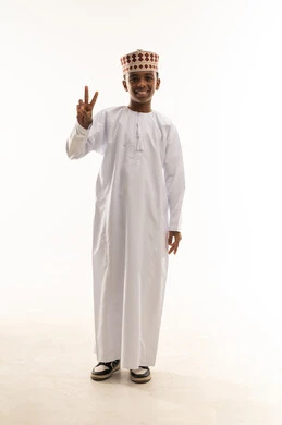 Omani Boy in Traditional Dress with Victory Sign Omani Boy in Traditional Dress with Victory Sign