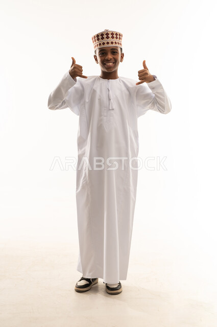Omani Boy in Traditional Dishdasha with Hand Gesture