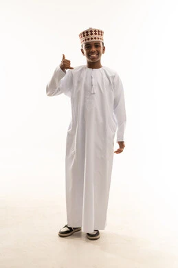Omani Boy in Traditional Dishdasha Making Hand Gesture