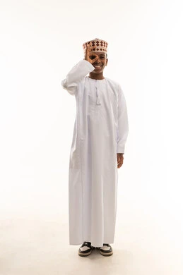 Omani Boy in Traditional Dishdasha Making OK Hand Sign
