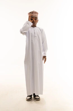Omani Boy in Traditional Dress with Hand Gesture Omani Boy in Traditional Dress with Hand Gesture
