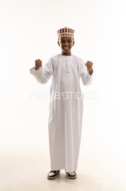 Omani Boy in Traditional Dress Celebrating Victory