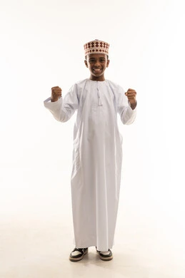 Omani Boy in Traditional Dress Celebrating Victory Omani Boy in Traditional Dress Celebrating Victory