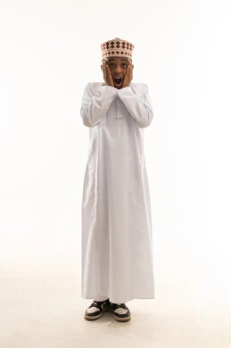 Shocked Omani Boy in Traditional Dishdasha and Kummah Shocked Omani Boy in Traditional Dishdasha and Kummah