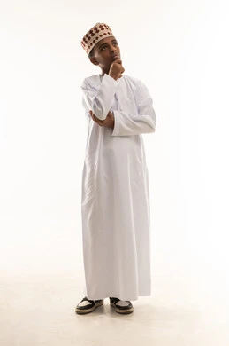 Omani Boy in Traditional Dishdasha Thinking Pose