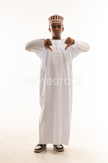 Omani Boy in Traditional Dress Giving Thumbs Down