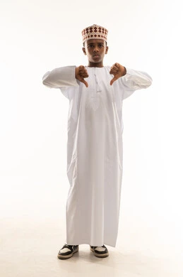 Omani Boy in Traditional Dress Giving Thumbs Down