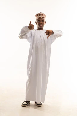 Omani Boy in Dishdasha with Thumbs Up and Down Gestures
