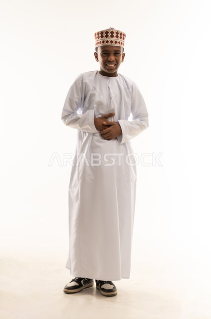 Omani Boy in Traditional Dishdasha and Kumma