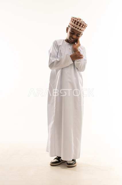 Omani Boy with Toothache in Traditional Dress