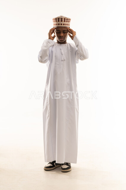 Omani Boy in Traditional Dress with Headache