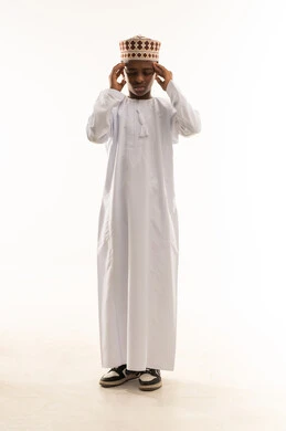 Omani Boy in Traditional Dress with Headache