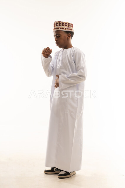 Omani Boy in Traditional Dishdasha and Kummah