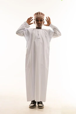 Omani Child Portrait in Traditional Dishdasha and Kumma