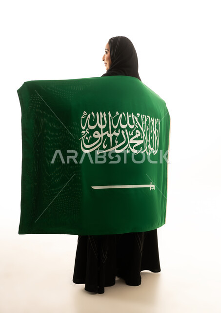 Saudi Woman Holding National Flag in Studio