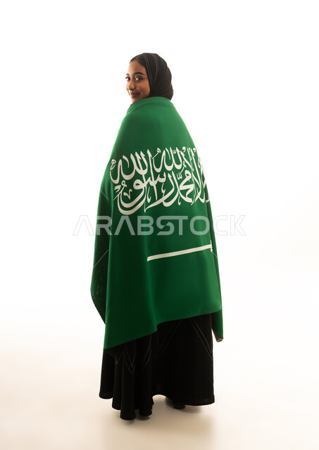 Saudi Woman Wrapped in National Flag on White Background