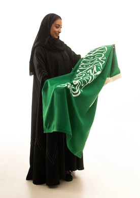 Saudi Woman Holding Saudi Flag on White Background