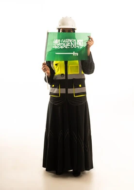 Saudi Female Engineer Holding Saudi Flag on White Background