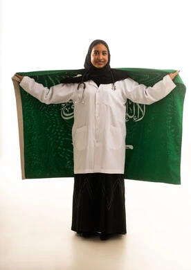 Saudi Female Doctor Holding National Flag in Studio